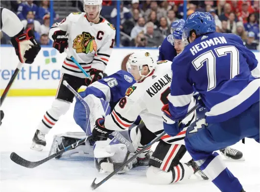  ?? CHRIS O’MEARA/AP ?? Kubalik scores one of his three goals during the Hawks’ five-goal third period Thursday against the Lightning in Tampa, Fla.