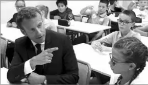  ??  ?? President Emmanuel Macron sits in a classroom of a secondary school in Laval, western France. (Photo: Courier Mail)