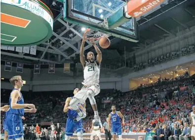  ?? DAVID SANTIAGO/EL NUEVO HERALD ?? Hurricanes forward Kamari Murphy dunks during the first half Saturday against Duke at the Watsco Center in Coral Gables.