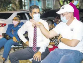  ??  ?? Chairman of General Accident Insurance (Jamaica) Limited PB Scott (right) talks with Tennis Jamaica President John Azar about the investment in the sport at the handing-over ceremony for the renovated courts C and D at the Liguanea Club on Wednesday, December 23, 2020.