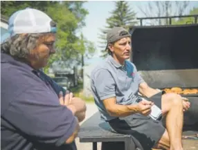  ?? Gabriel Scarlett, The Denver Post ?? Mike Fernandez, left, and Jeff Kennedy, two of the three founders of Moe’s Original Bar B Que, talk outside their flagship restaurant in Eagle.