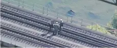  ?? Photos: Court exhibit ?? Chiheb Esseghaier and Raed Jaser examine a railway bridge with an undercover FBI agent.