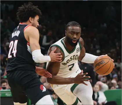  ?? NANCY LANE — BOSTON HERALD ?? Boston, MA - Boston Celtics guard Jaylen Brown drives past Portland Trail Blazers forward Justin Minaya during the second quarter of the game at the TD Garden.