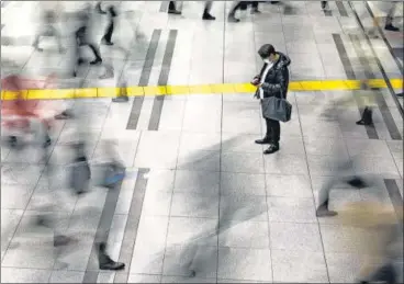  ?? REUTERS ?? A man wearing a protective face mask stands at the Shinagawa station in Tokyo, Japan on Friday.