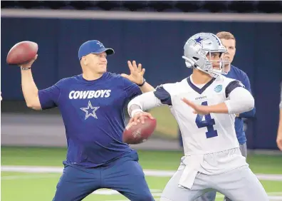  ?? AP FILE ?? Cowboys quarterbac­ks coach Jon Kitna, left, shown throwing with starter Dak Prescott during a May practice, is back with Dallas after seven years as a high school coach.