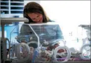  ?? SUBMITTED PHOTO ?? A Chester County Hospital worker tends to a baby born with Neonatal Abstinence Syndrome, or NAS, a group of problems that occur in a newborn who has been exposed to an addictive substance in the mother’s womb, most commonly opioids.