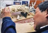  ?? YANG YAO / CHINA DAILY ?? An artist carves a piece of ivory at the Beijing Ivory Carving Factory in 2013.