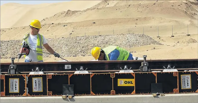  ?? CHEMA MOYA / EFE ?? Unos operarios trabajan sobre la línea del AVE La Meca-Medina, en un punto del desierto a cien kilómetros de Yida