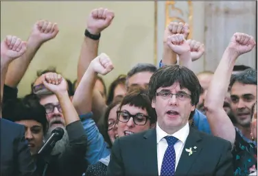  ?? AP/MANU FERNANDEZ ?? President Carles Puigdemont of the Catalan region joins in the Catalan anthem Friday with members of parliament after a vote for independen­ce Friday in Barcelona, Spain.