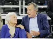  ?? DAVID J. PHILLIP — THE ASSOCIATED PRESS FILE ?? In this file photo, former President George H.W. Bush and his wife Barbara Bush, left, speak before a college basketball regional final game between Gonzaga and Duke, in the NCAA basketball tournament in Houston. A family spokesman said Sunday that the...