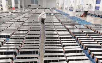  ?? AFP via Getty Images/TNS ?? A worker looks over car batteries in a factory for Xinwangda Electric Vehicle Battery Co. Ltd in Nanjing in China’s eastern Jiangsu province.