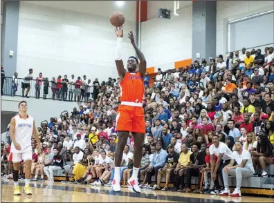  ?? Arkansas Democrat-Gazette/JEFF GAMMONS ?? Former University of Arkansas standout and current New York Knicks forward Bobby Portis launches a shot Sunday during his charity basketball game at Little Rock Hall’s Cirks Arena. Portis had a game-high 50 points.
