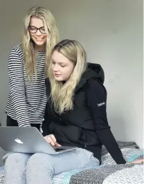  ??  ?? Chilling . . . Meg Hurring (18, left) and Paige Brazier (19) surf the internet in a dorm room.