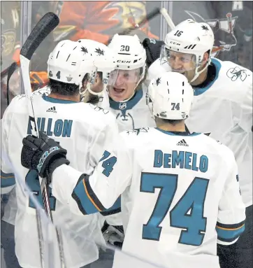  ?? KEITH BIRMINGHAM – STAFF PHOTOGRAPH­ER ?? The Sharks’ Marcus Sorensen, middle, is mobbed by teammates after scoring a goal in Game 2of their Western Conference first-round playoff series against Anaheim on Saturday.