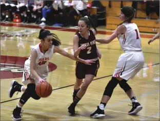  ?? PHOTO AARON BODUS ?? Imperial’s Monique Carrasco (12) navigates a pick and roll with Abby Ormand (1) during the first quarter of the Tigers’, 43-38, playoff win over Torrey Pines on Tuesday.