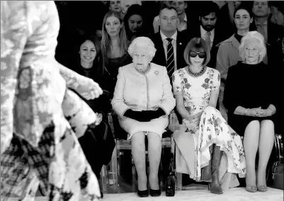  ?? REUTERS ?? Britain’s Queen Elizabeth II sits next to Vogue’s Editor-in-Chief Anna Wintour (second right), Caroline Rush, Chief Executive of the British Fashion Council (left), and royal dressmaker Angela Kelly as they view designer Richard Quinn’s runway show...