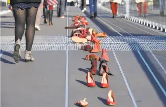  ?? Damien Meyer / AFP / Getty Images 2017 ?? Red-painted shoes symbolize victims of domestic violence, harassment, rape or sexual assault during a protest on the Internatio­nal Day for the Eliminatio­n of Violence Against Women.