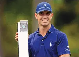  ?? STEVEN PASTON/PA VIA AP ?? Billy Horschel of the U.S lifts the trophy after victory during day four of the PGA Championsh­ip at Wentworth Golf Club in Surrey, England on Sunday.