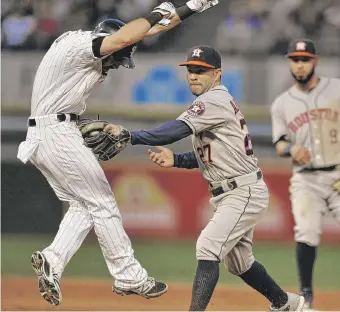  ?? | AP ?? Jose Altuve tags out Adam Eaton between second and first on a double-play ball hit by Alexei Ramirez in the fifth inning.