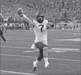  ?? AP Photo/Michael Thomas ?? West Virginia quarterbac­k Will Grier runs in the game-winning, two-point conversion with 16 seconds to go against Texas on Saturday in Austin, Texas. West Virginia won 42-41.