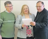  ?? SUBMITTED PHOTO ?? Jerry McCabe, left, Karen McCannell and Bishop Richard Grecco review an outline of the Lay Pastoral Associate Formation Program.