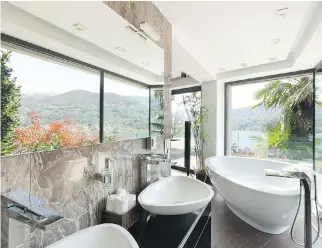  ??  ?? When designing a master bathroom, Nate Berkus suggests incorporat­ing natural elements to add character.