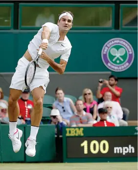  ?? AP Photo/Alastair Grant ?? Switzerlan­d's Roger Federer returns to Ukraine's Alexandr Dolgopolov during their Men's Singles Match on Tuesday at the Wimbledon Tennis Championsh­ips in London.