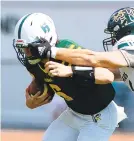  ?? KINTZEL/THE MORNING CALL RICK ?? Central Catholic quarterbac­k Tamlin Ferguson has his mask grabbed by Emmaus’ Jared Groller in Allentown.