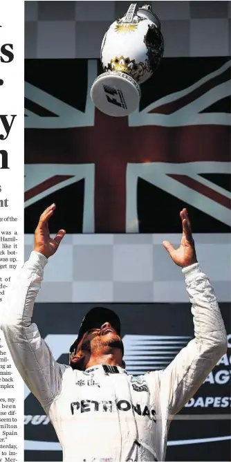  ??  ?? PRIZE IS MINE: Lewis Hamilton enjoys his win in Hungary