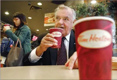  ?? Canadian Press file photo ?? Ron Joyce, co-founder of Tim Hortons, sips a coffee in Toronto in this October 2006 file photo. Joyce has died at age 88.