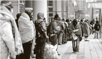  ?? Karen Warren / Staff photograph­er ?? The city opened the George R. Brown Convention Center as an emergency shelter for homeless people to get out of the freezing temperatur­es. Many organizati­ons continue to offer help.