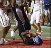  ?? ?? Los Alamitos' Jerod Terry Jr. cradles the ball in the end zone for a touchdown against Edison.