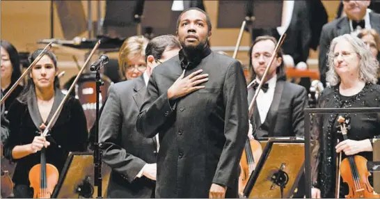  ?? ARMANDO L. SANCHEZ/CHICAGO TRIBUNE ?? Kedrick Armstrong looks up after conducting the Adrian Dunn Singers and members of the Chicago Sinfoniett­a in a performanc­e of “Seven Last Words of the Unarmed” on Jan. 20.