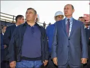  ?? ALEXEI DRUZHININ / SPUTNIK, KREMLIN, POOL PHOTO VIA AP ?? Russian President Vladimir Putin (right), flanked by businessma­n and billionair­e Arkady Rotenberg, visit the constructi­on site of the Kerch Strait bridge in Kerch, Crimea.