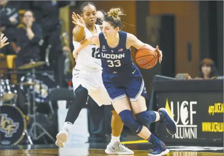  ?? Reinhold Matay / Associated Press ?? UConn’s Katie Lou Samuelson (33) dribbles around Central Florida’s Nyala Shuler (12) during on Sunday in Orlando, Fla.