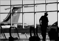  ?? ERIC MILLER/REUTERS ?? A Northwest Airlines pilot pulls his luggage at the Minneapoli­s- St. Paul Internatio­nal Airport in Minnesota yesterday, when the fourth-largest carrier in the U.S. filed for creditor protection.