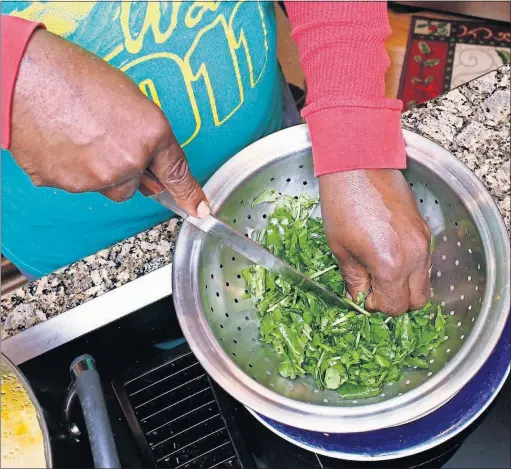  ?? [FRED SQUILLANTE /DISPATCH] ?? The kale that Joseph Mckelvey chopped up for his soup was just one of the healthy ingredient­s in it. The soup also included squash, onions, celery, carrots, great Northern beans, rosemary and thyme.