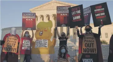  ??  ?? 0 Opponents of Amy Coney Barrett demonstrat­e outside the US Supreme Court