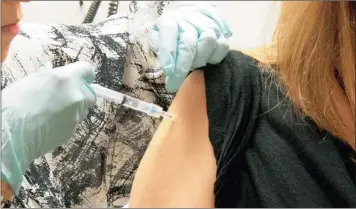  ?? PICTURE: NIAID / AP ?? TRIAL AND ERROR: A volunteer receives a dose of the NIAID/GSK Ebola trial vaccine at the National Institute of Health Clinical Center in Bethesda.