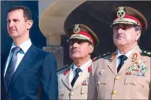  ??  ?? File photo shows Syrian President Bashar Assad standing next to Syrian Defense Minister Gen. Dawoud Rajha (right) during a ceremony to mark the 38th anniversar­y of the October 1973 ArabIsrael­i war in Damascus.