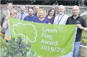  ??  ?? Celebratin­g Rhyddings Park’s green flag are, from left: Peter Jordan, director of Newground Together; Ann Warrington, chair of Friends of Rhyddings Park; Craig Haraben, HBC deputy head environmen­tal Services; Chris Sharpe, gardener; Gordon Mason foreman gardener; Joanne Shaw, Newground’s Volunteer Engagement Officer; Shirley Parkinson, green spaces officer; Andrew Hayhurst, senior parks dev officer and Coun Paul Cox, cabinet member for parks and open spaces.