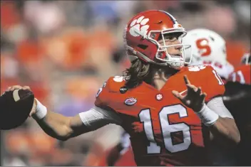  ?? ASSOCIATED PRESS ?? CLEMSON QUARTERBAC­K TREVOR LAWRENCE (16) makes a pass during an NCAA game against Syracuse in Clemson, S.C., on Saturday.