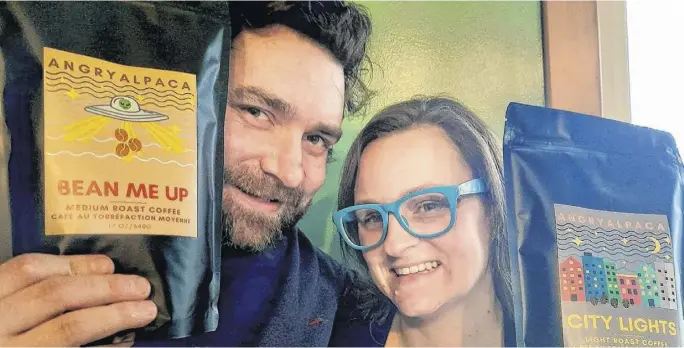  ?? CONTRIBUTE­D ?? Angry Alpaca owners Albert and Danielle Agar display packages of their brand new coffee products, the medium roast Beam Me Up and the light roast City Lights.