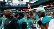  ?? WILFREDO LEE ?? AP PHOTO BY Miami Dolphins defensive end Robert Quinn (94) raises his right fist during the singing of the national anthem, before th game Aug. 9.