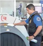  ?? JAY JANNER/USA TODAY NETWORK ?? A TSA screening officer uses Lysol spray March 5 to disinfect screening equipment in Austin, Texas.