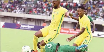  ??  ?? Bafana Bafana defender Mphahlele Ramahlwe (left) leaves Super Eagles’ Elderson Echiejile sprawling on the turf during the AFCON 2019 qualifying match between Nigeria and South Africa in Uyo… last Saturday
Duro Ikhazuagbe