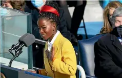  ?? AP ?? Inaugural poet Amanda Gorman reads a poem after Joe Biden was sworn in as the 46th President of the United States.