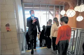  ?? NANCY LANE/BOSTON HERALD ?? Gov. Charlie Baker waves to students during a visit to West Parish School in Gloucester on Wednesday. The school has had in person learning for 101 days.