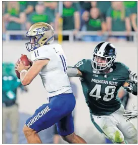  ?? [AL GOLDIS/THE ASSOCIATED PRESS] ?? Michigan State’s Kenny Willekes, right, sacks Tulsa quarterbac­k Zach Smith during the fourth quarter Aug. 30 in East Lansing, Mich.