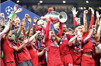  ??  ?? Liverpool captain Jordan Henderson lifts the Champions League trophy. - AFP photo